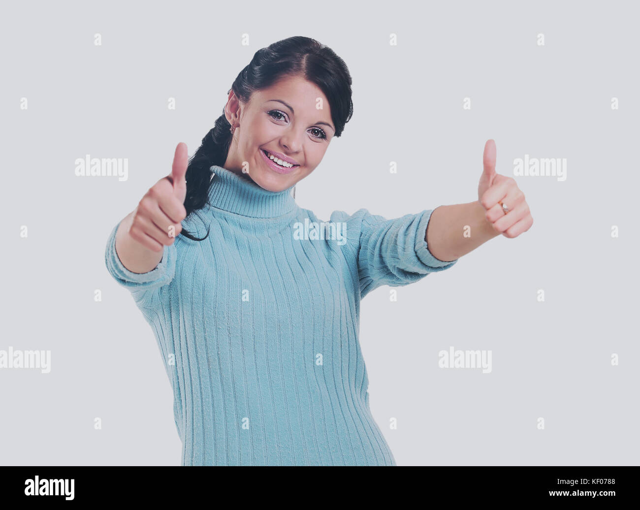 Attractive young woman  gives thumbs up to camera Stock Photo