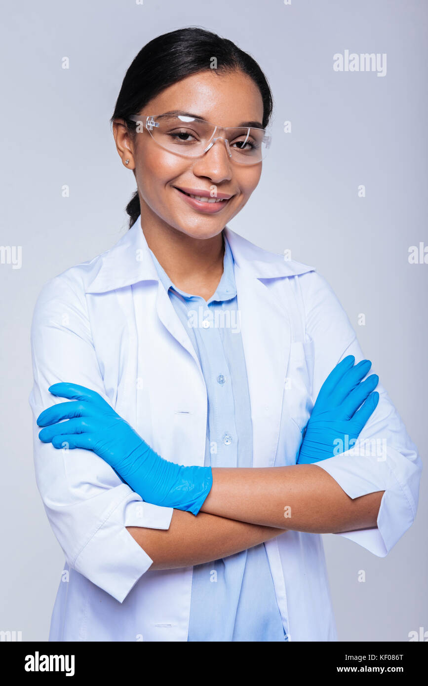 Beautiful lab worker folding her hands in latex gloves Stock Photo - Alamy