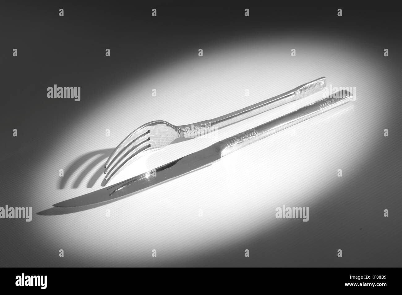 Knife and fork casting a shadow Stock Photo Alamy