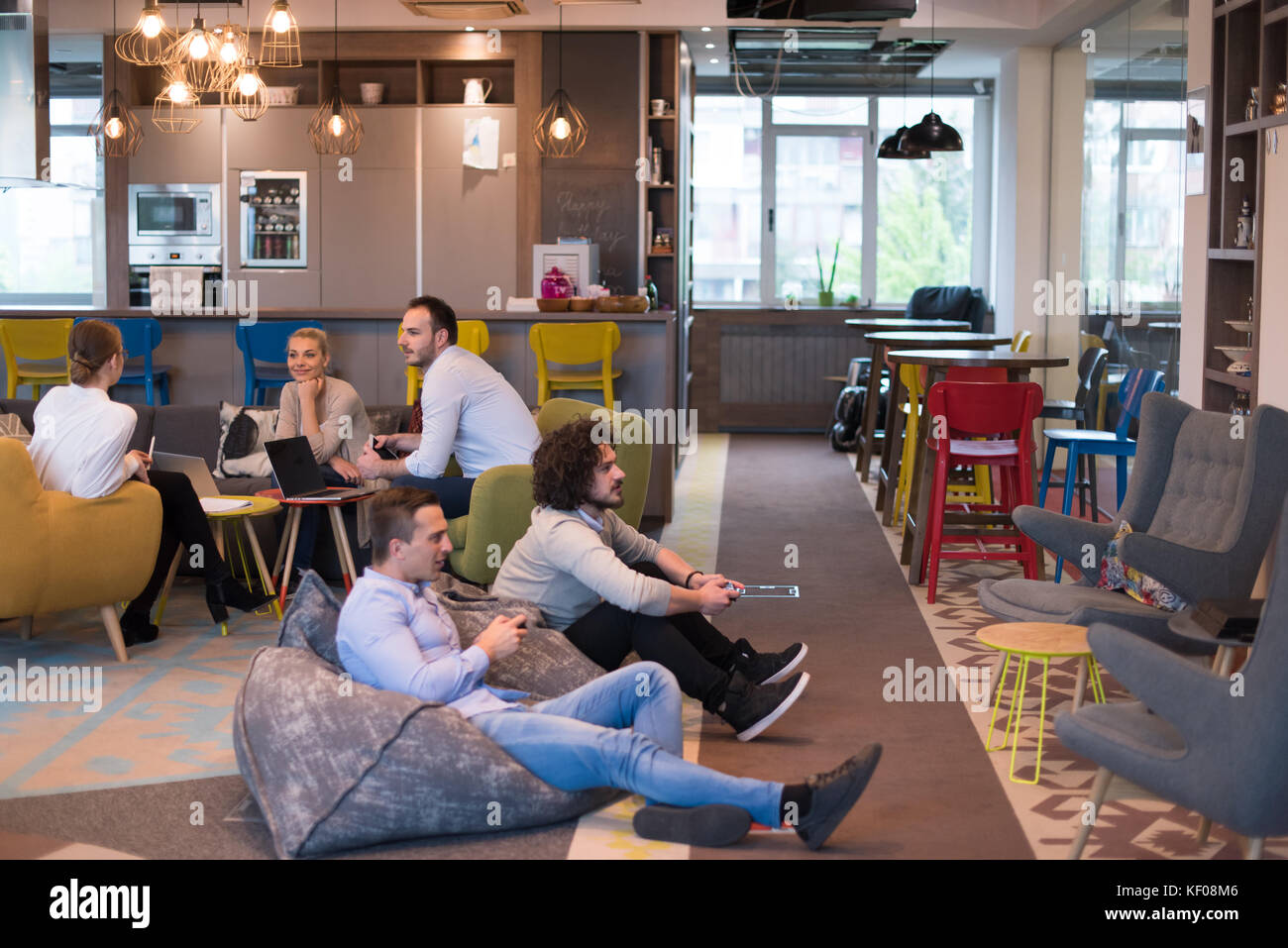 Work hard play hard. Workers Playing computer games in creative startup ...