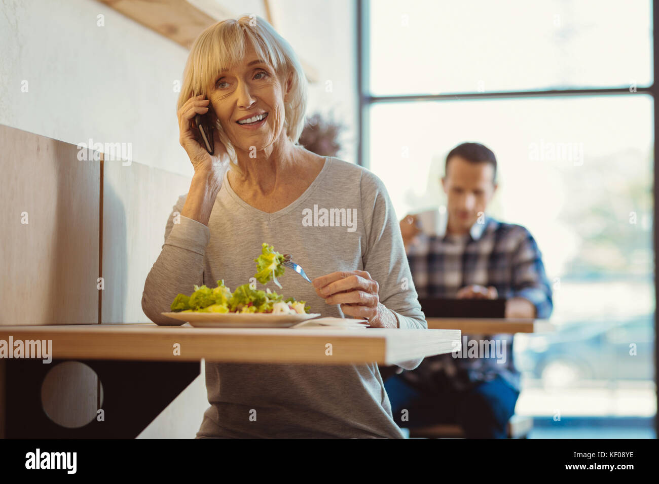 Nice elderly woman being busy Stock Photo