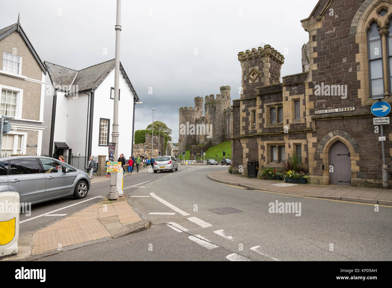 Conwy town high street scene, castle in background Stock Photo