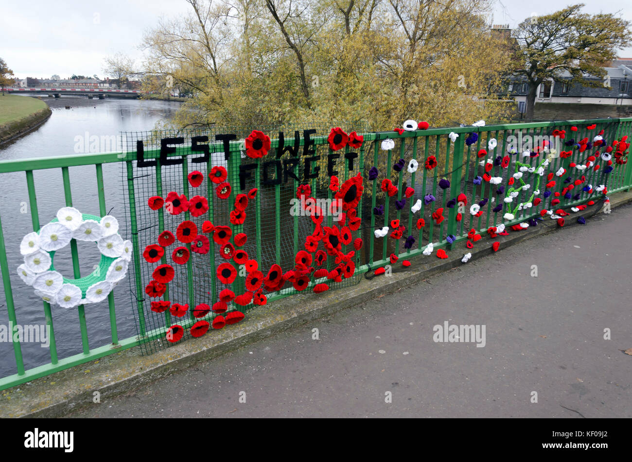 Knitted remembrance poppies on the railings of a bridge in Musselburgh, near Edinburgh, Scotland. Stock Photo