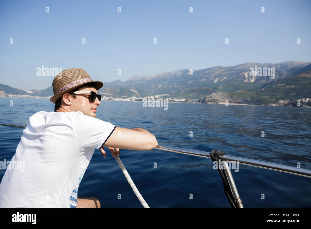 man aboard a boat looking at the sea Stock Photo - Alamy