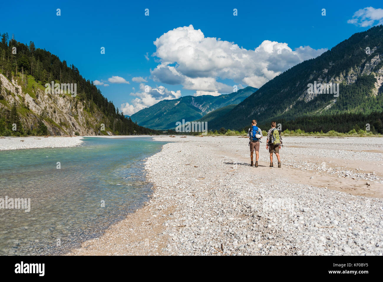 Germany, Bavaria, back view of two hikers with backpacks walking in dry ...