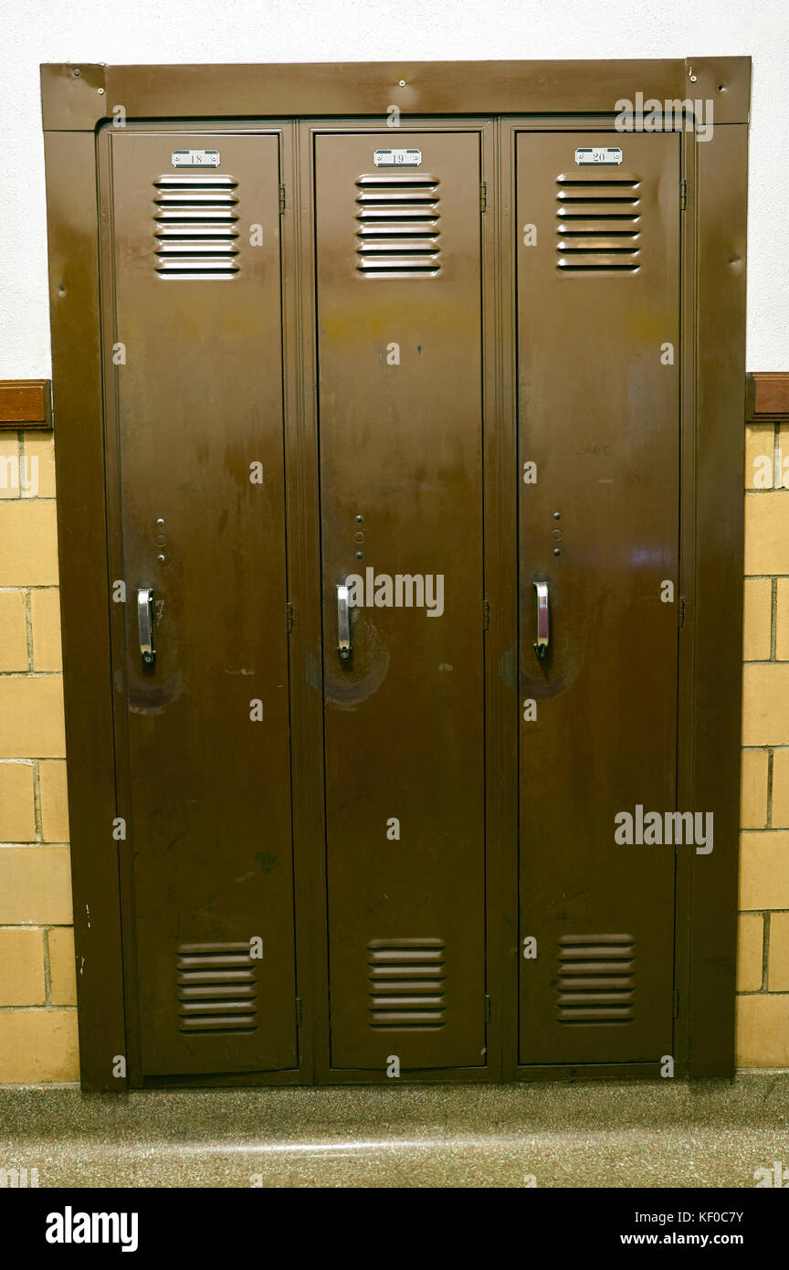 Three solid steel, wall mounted storage cupboard lockers in a vertical
