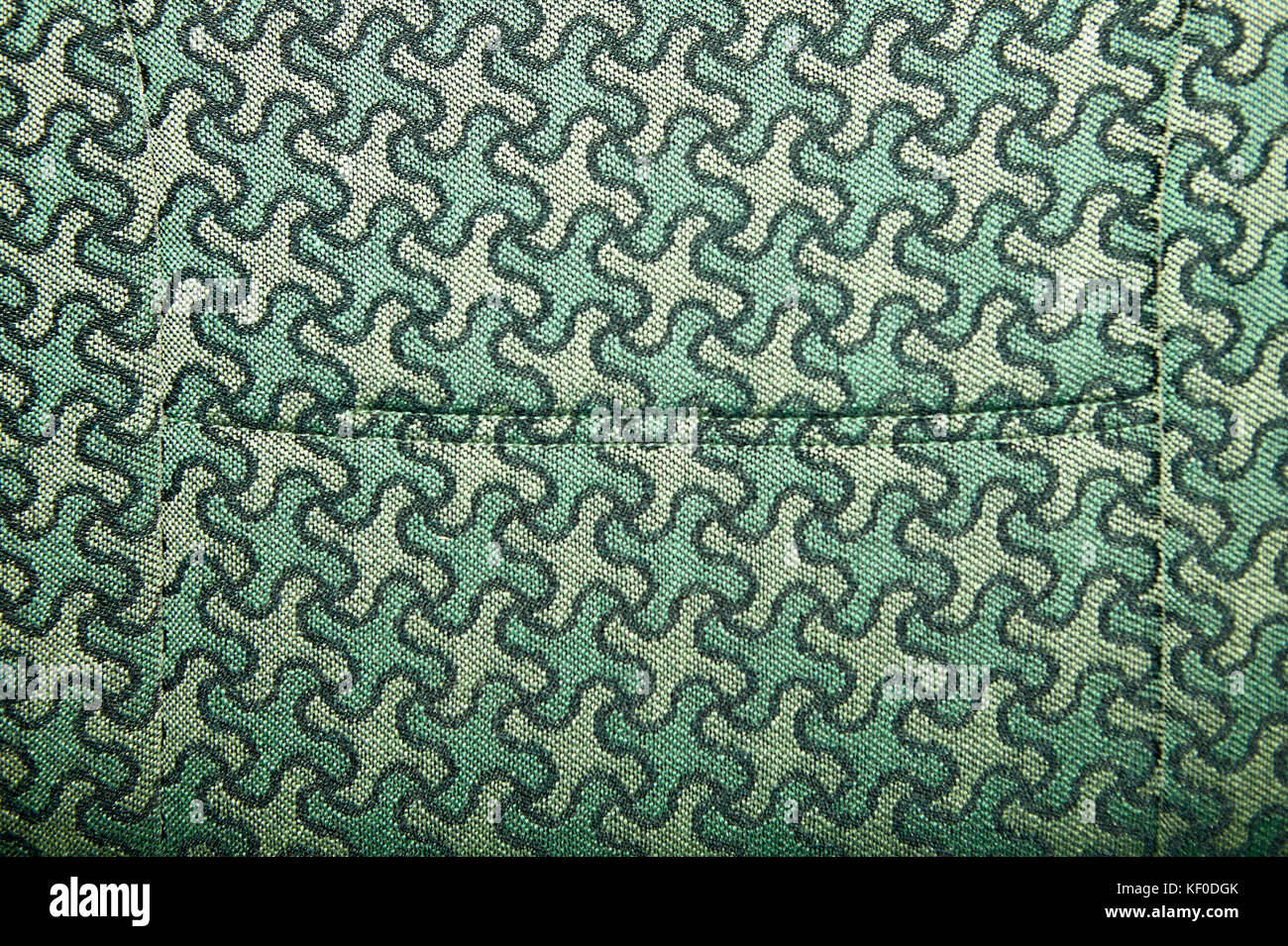 Close up view of a green and light green fabric pattern upholstery design on a large piece of furniture Stock Photo