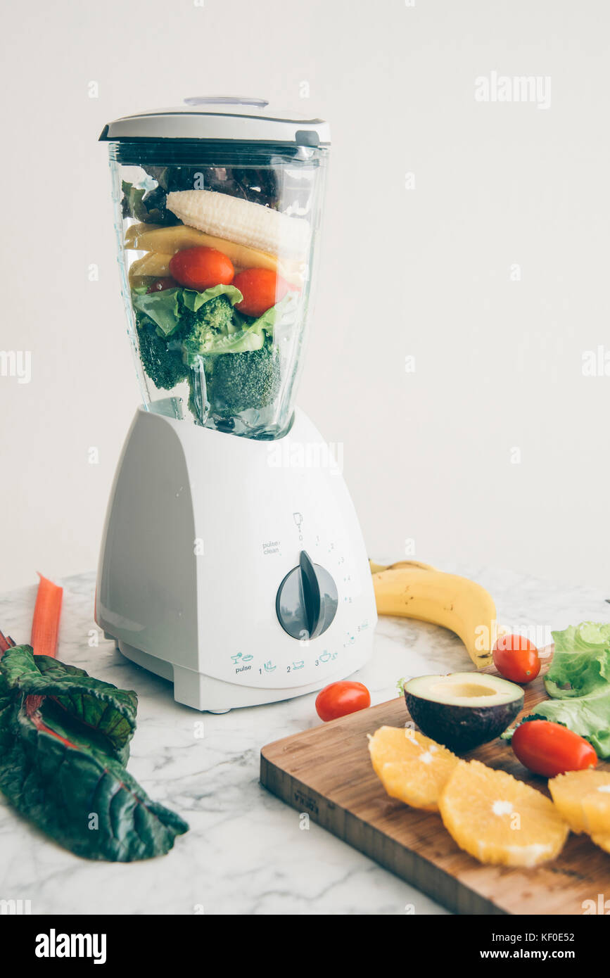 Blender filled with fruits and vegetables Stock Photo Alamy
