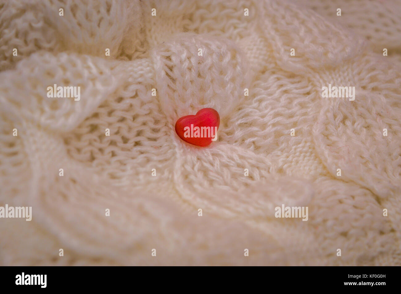 Red heart on a white knitted fabric background Stock Photo - Alamy