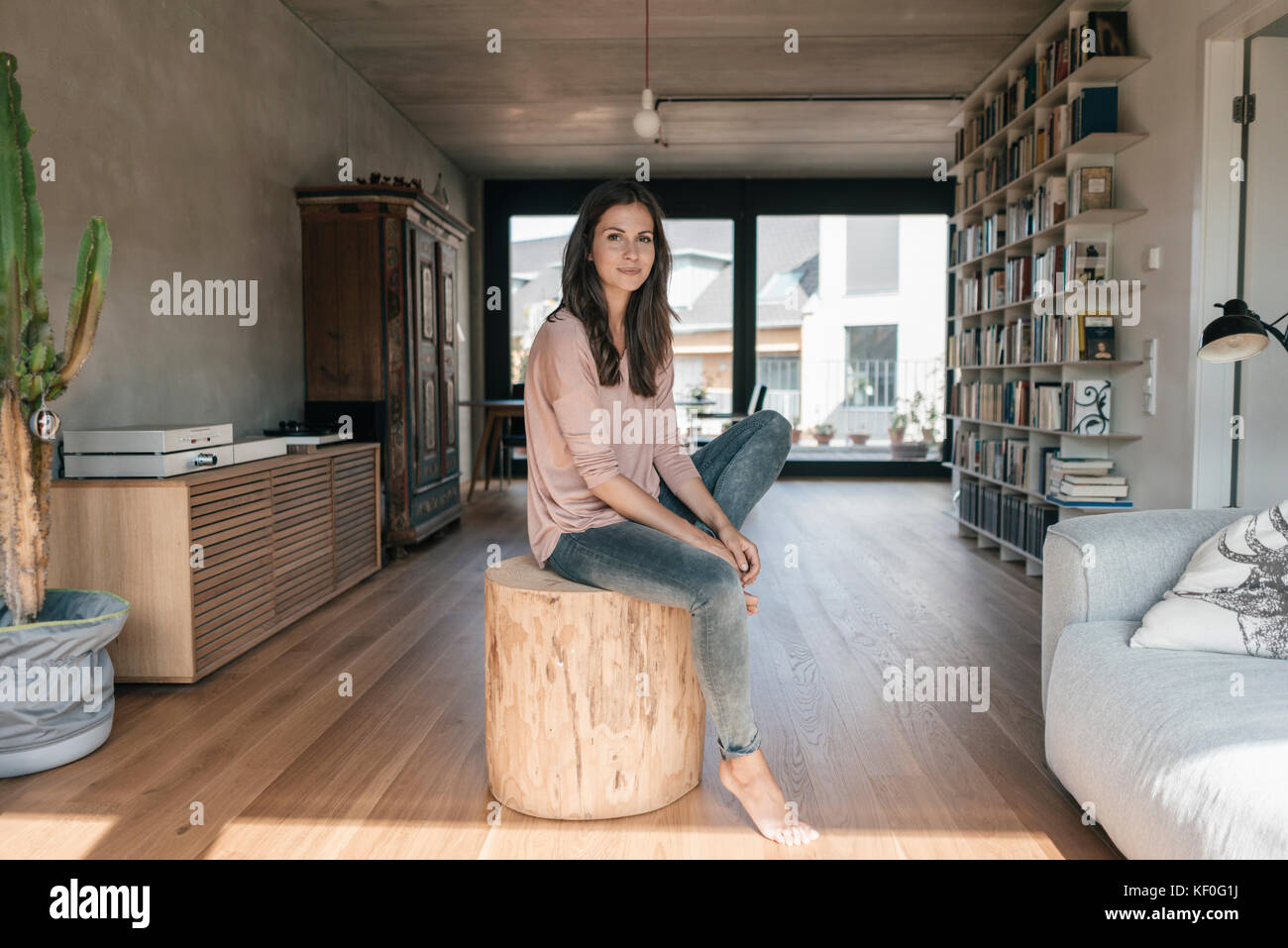 Portrait of smiling woman relaxing at home Stock Photo - Alamy