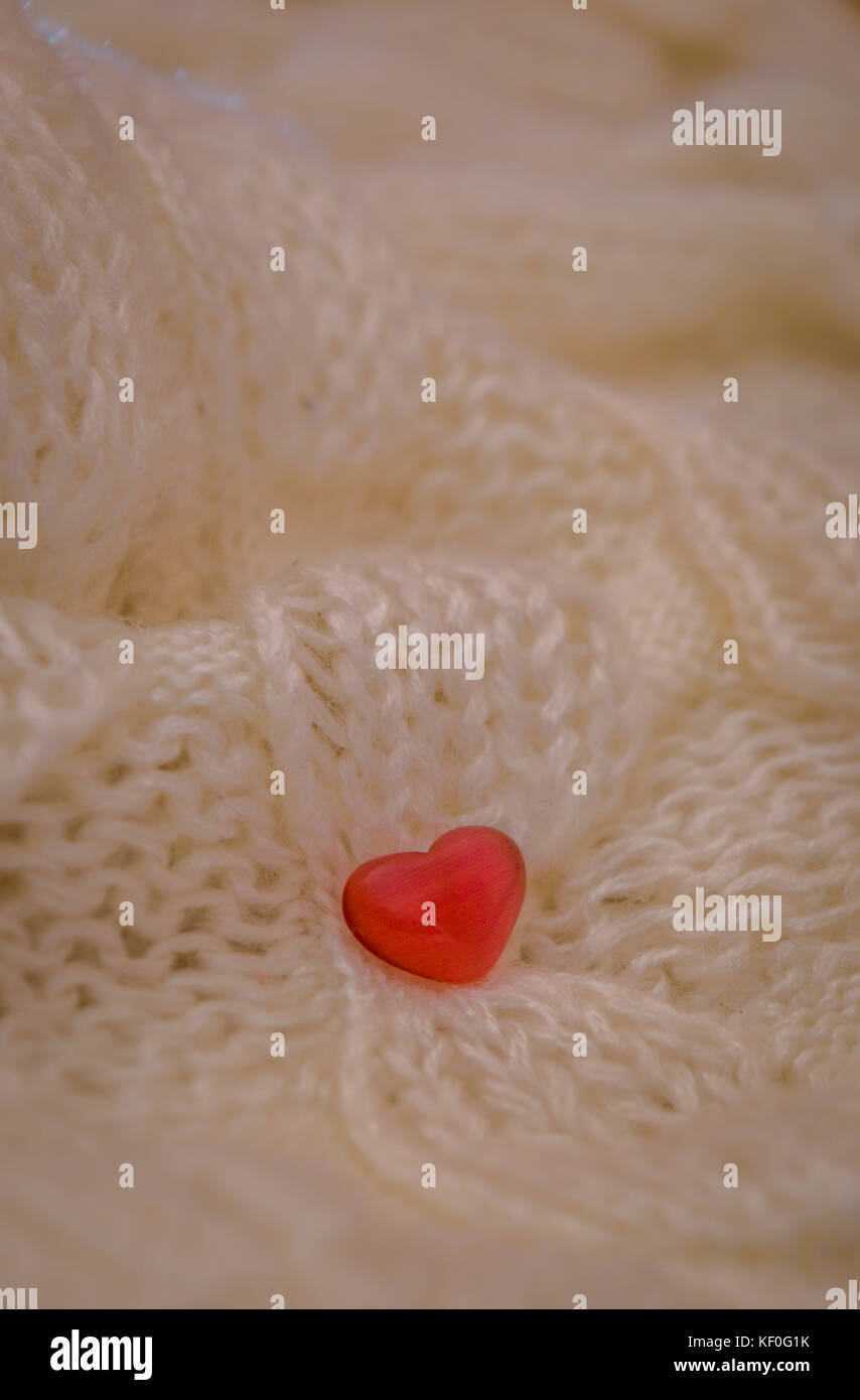 Red heart on a white knitted fabric background Stock Photo - Alamy