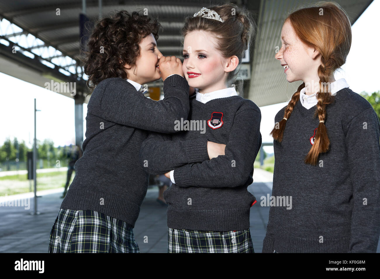 Three girls at platform wearing school uniform Stock Photo