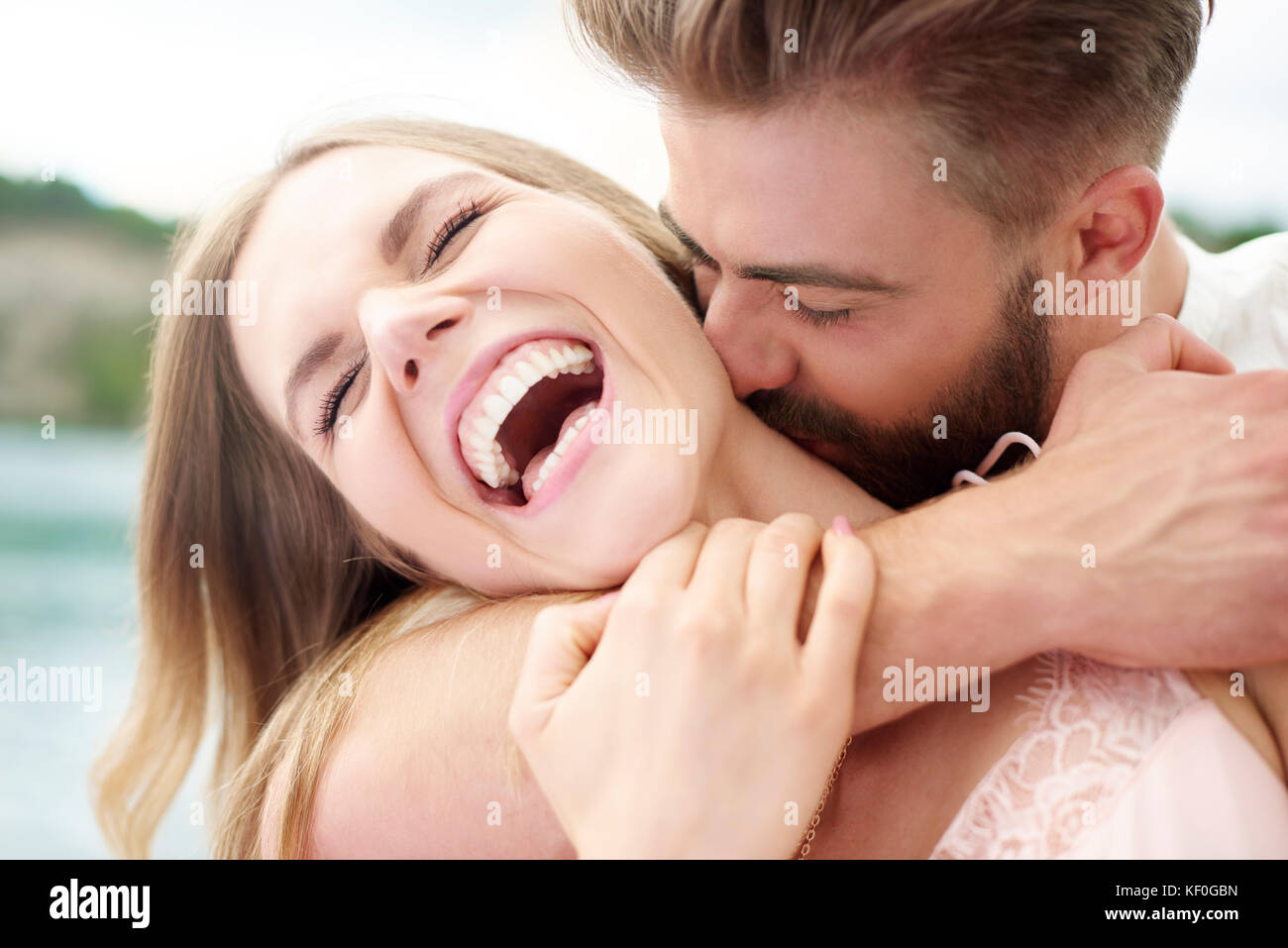 Man giving his girlfriend a neck kisses, Krakow, Malopolskie, Poland Stock Photo