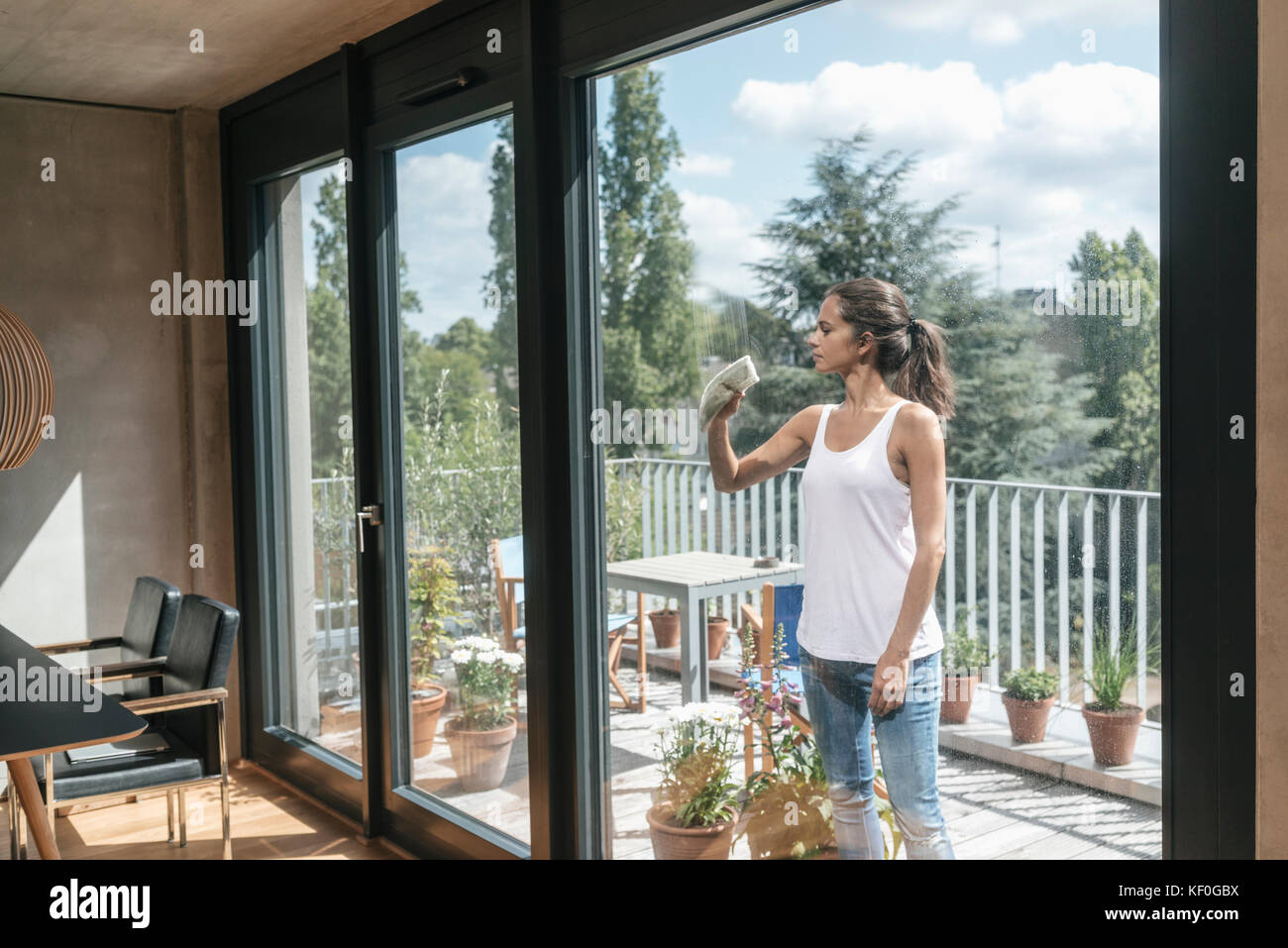 Woman cleaning balcony window Stock Photo Alamy