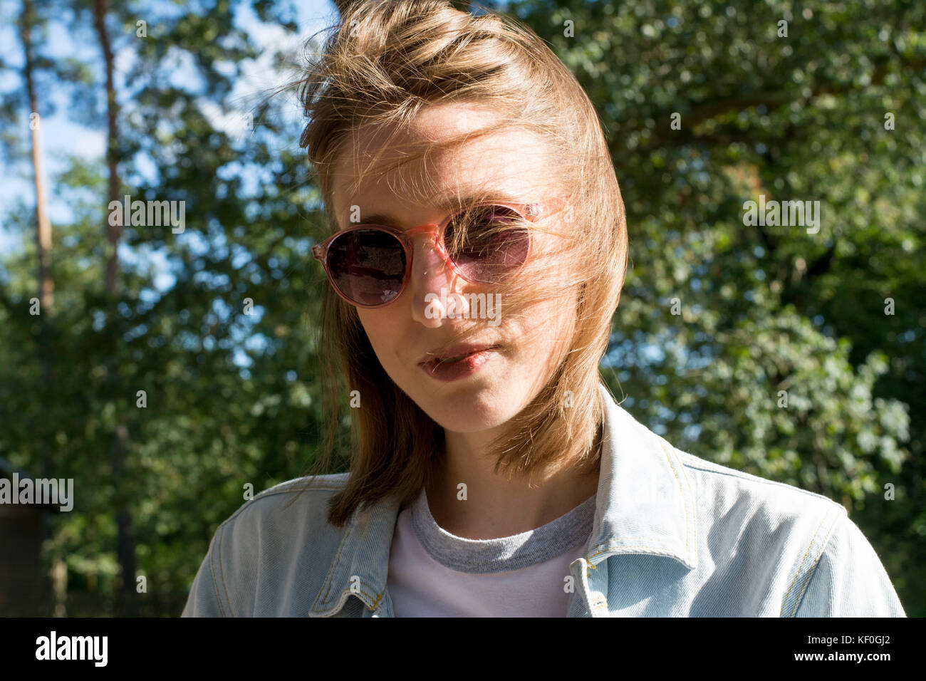 Portrait of a young woman in nature, wearing sunglasses Stock Photo - Alamy