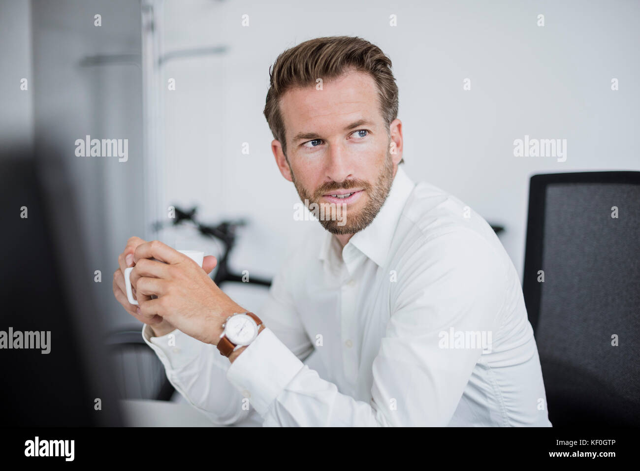 Portrait of businessman with coffee cup in the office Stock Photo