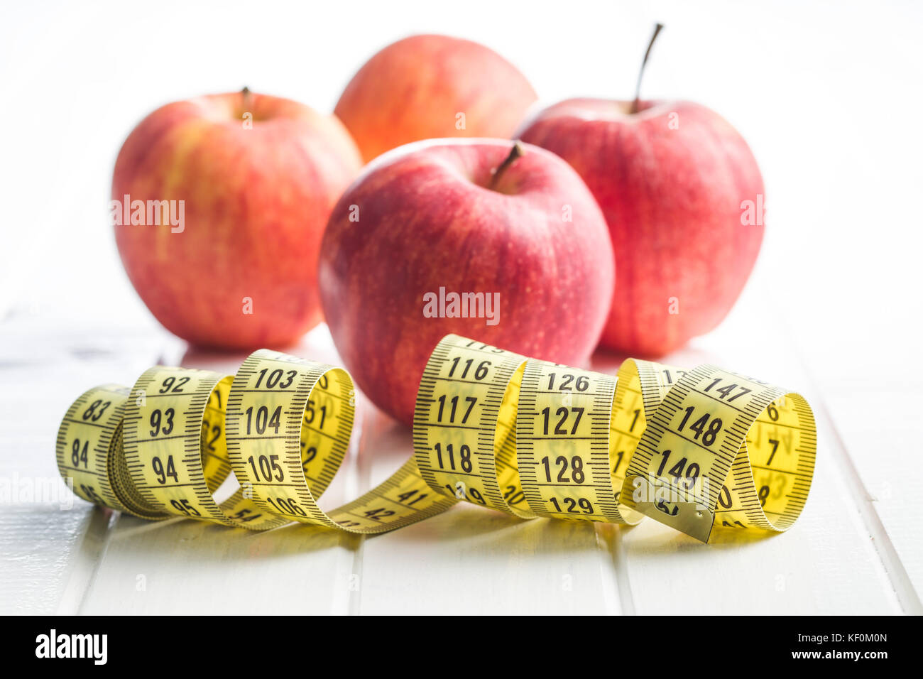Red apple and measuring tape. Diet concept. Stock Photo