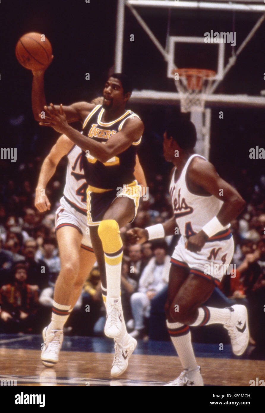 Magic Johnson of the Los Angeles Lakers bringing the ball up court during a game against the New Jersey Nets at the Brendan Byrne Arena in the Meadowl Stock Photo
