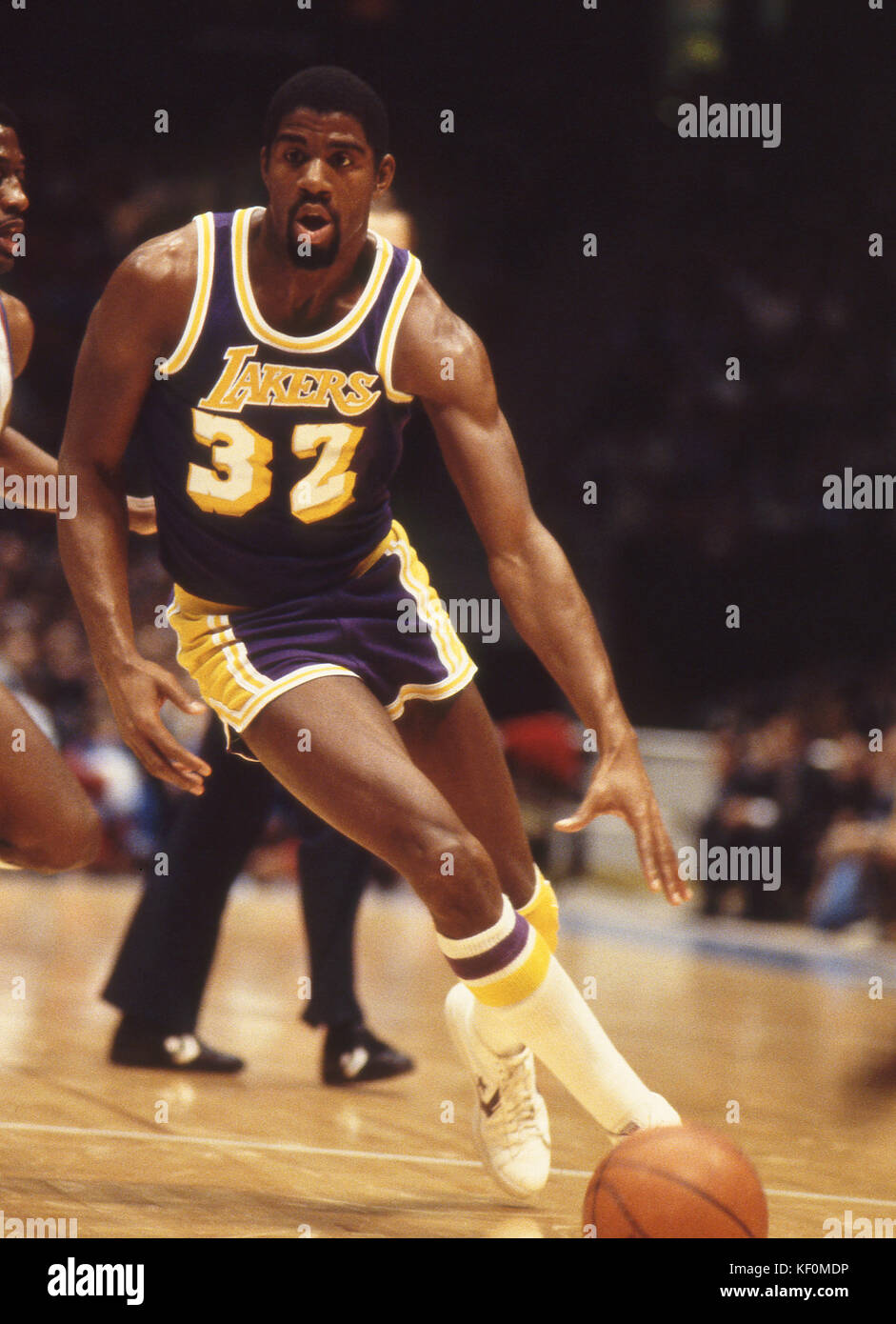 Magic Johnson of the Los Angeles Lakers bringing the ball up court during a game against the New Jersey Nets at the Brendan Byrne Arena in the Meadowl Stock Photo