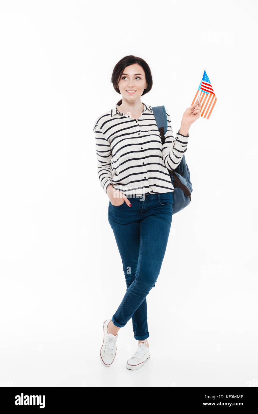 Full length portrait of a cute teenage girl with backpack holding US ...