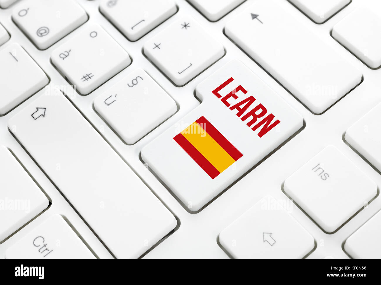 Learn Spanish language education web concept. Spain flag enter button or key on white keyboard Stock Photo