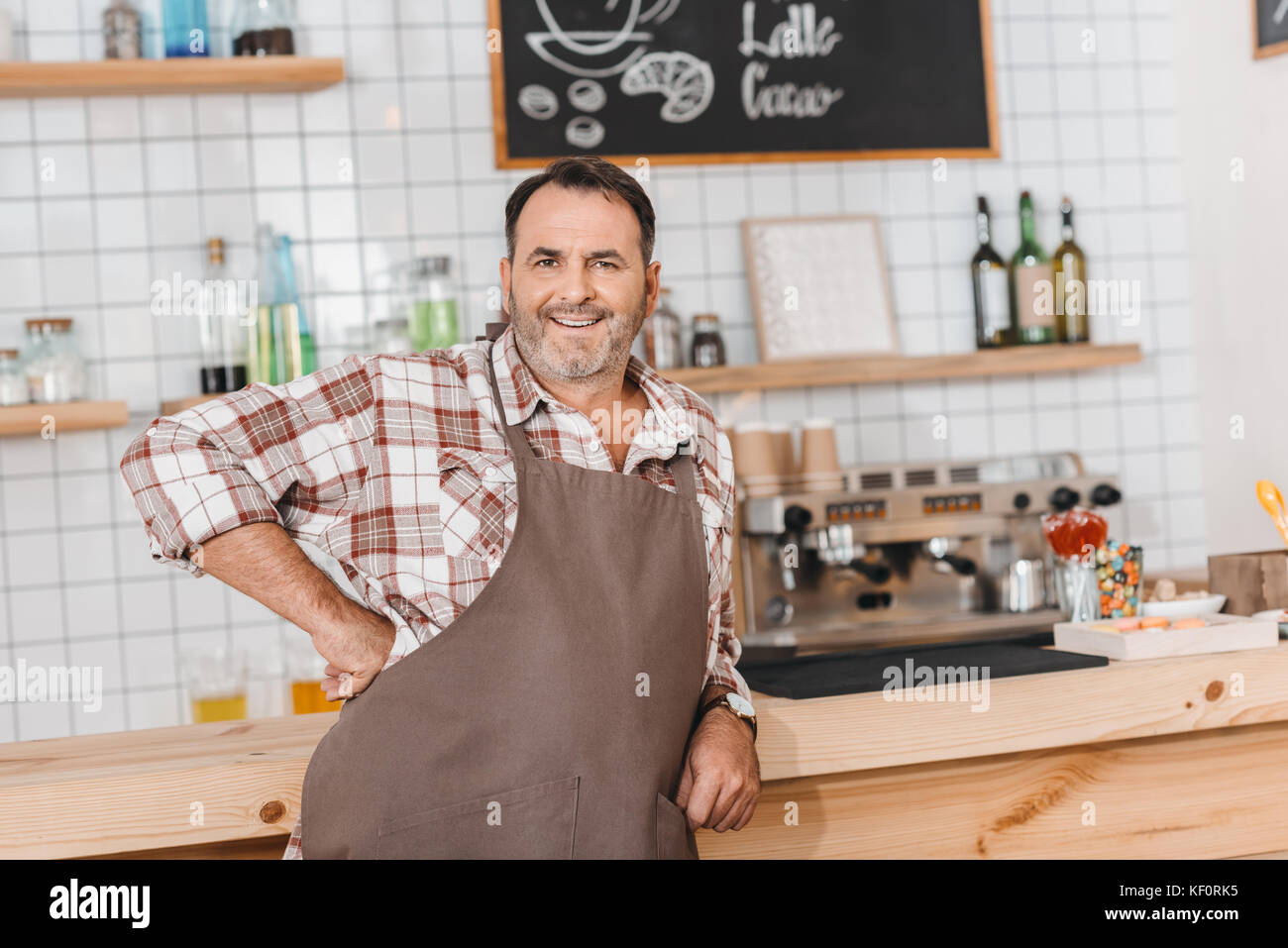 bartender leaning on bar counter Stock Photo