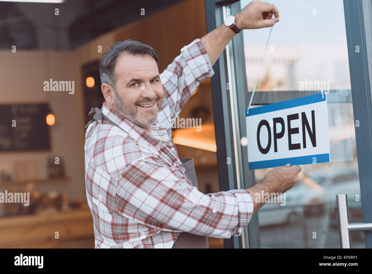 bartender hanging open sign on door Stock Photo Alamy