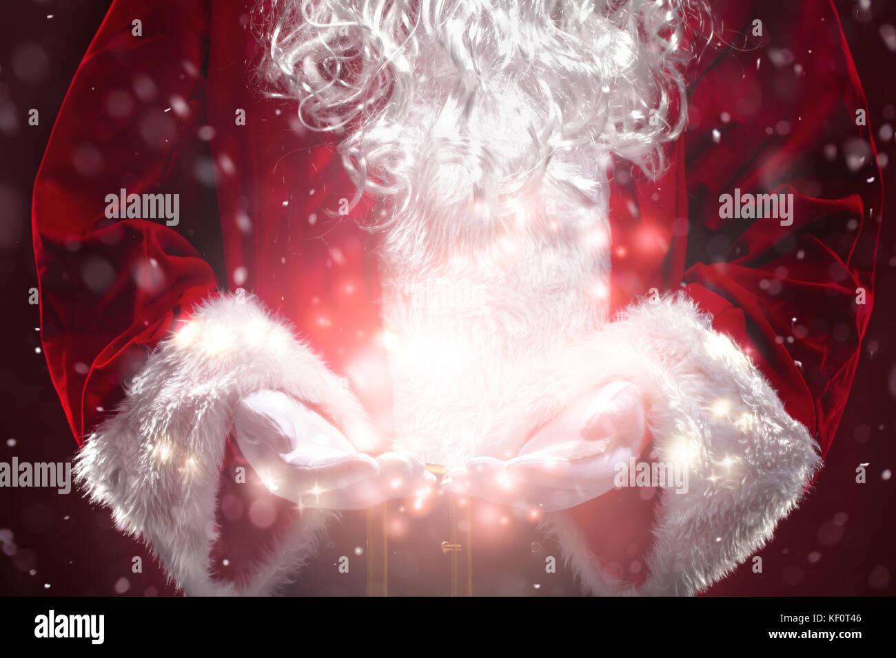 Santa Claus with magic Christmas lights in hands Stock Photo