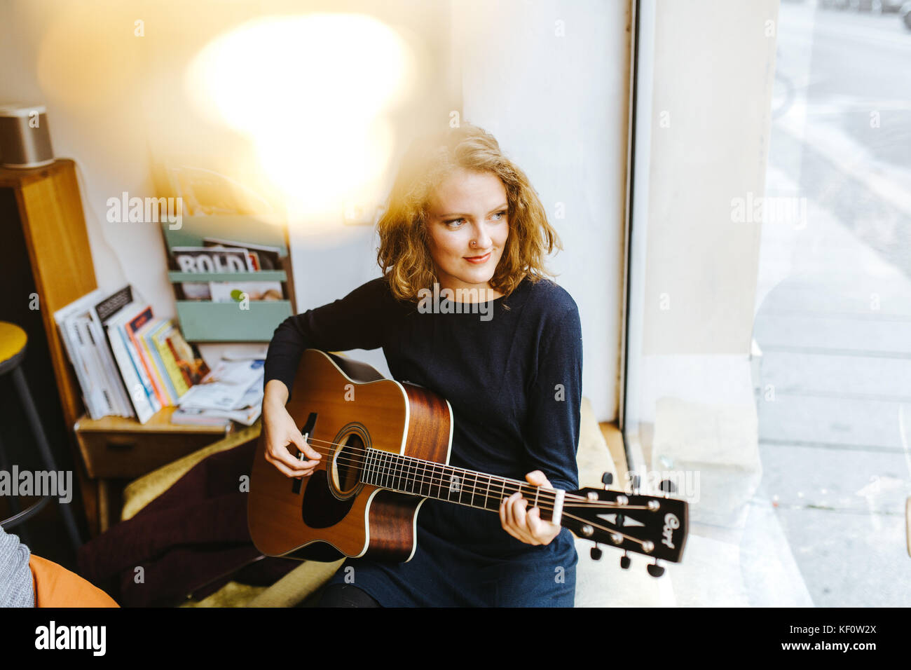 blonde female singer playing a song Stock Photo