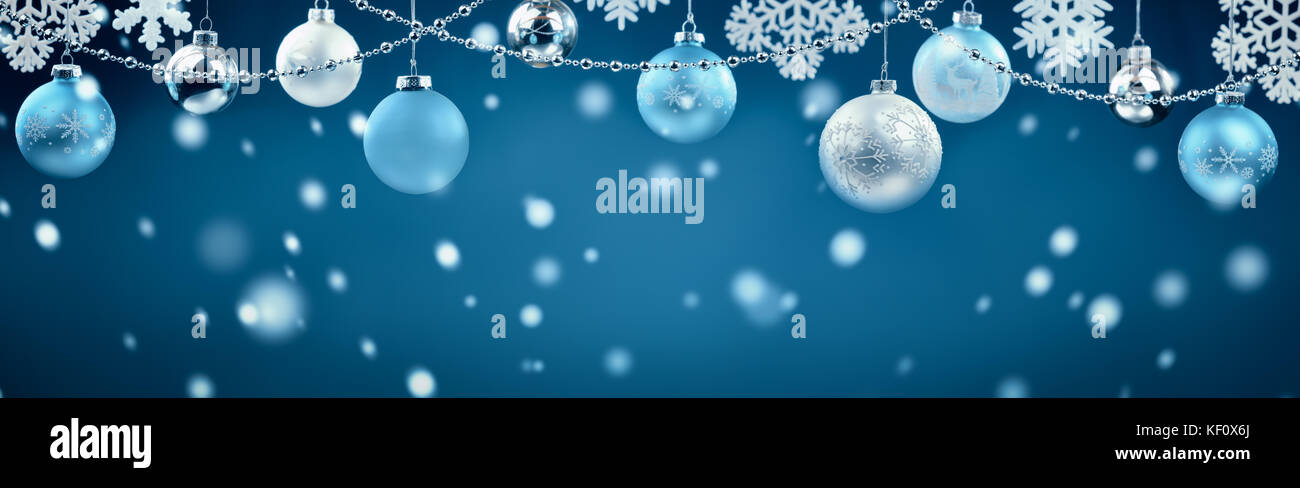 Christmas balls hanging on blue background Stock Photo - Alamy