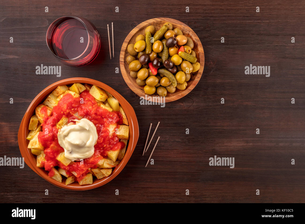 Overhead photo of traditional Spanish tapas. Pickled olives, patatas