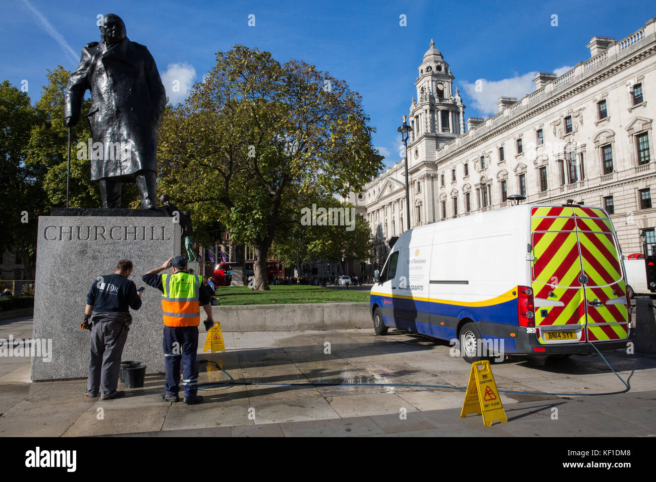 London, UK. 25th October, 2017. Employees of cleaning company Veolia use a variety of procedures to try to remove graffiti including the word 'Nazi' which appeared on 24th October on the statue of Sir Winston Churchill opposite the Palace of Westminster in Parliament Square. Police arrested a man at around 9.45pm on 24th October on suspicion of criminal damage. Credit: Mark Kerrison/Alamy Live News Stock Photo