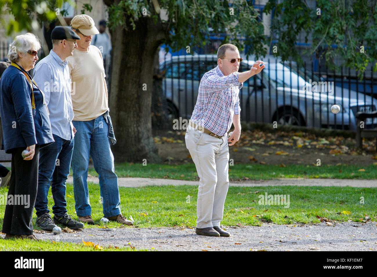 Bath, UK, 25th October, 2017. UK Weather:  People enjoying the autumn sunshine are pictured playing Boules in Queen Square. Credit: lynchpics/Alamy Live News Stock Photo