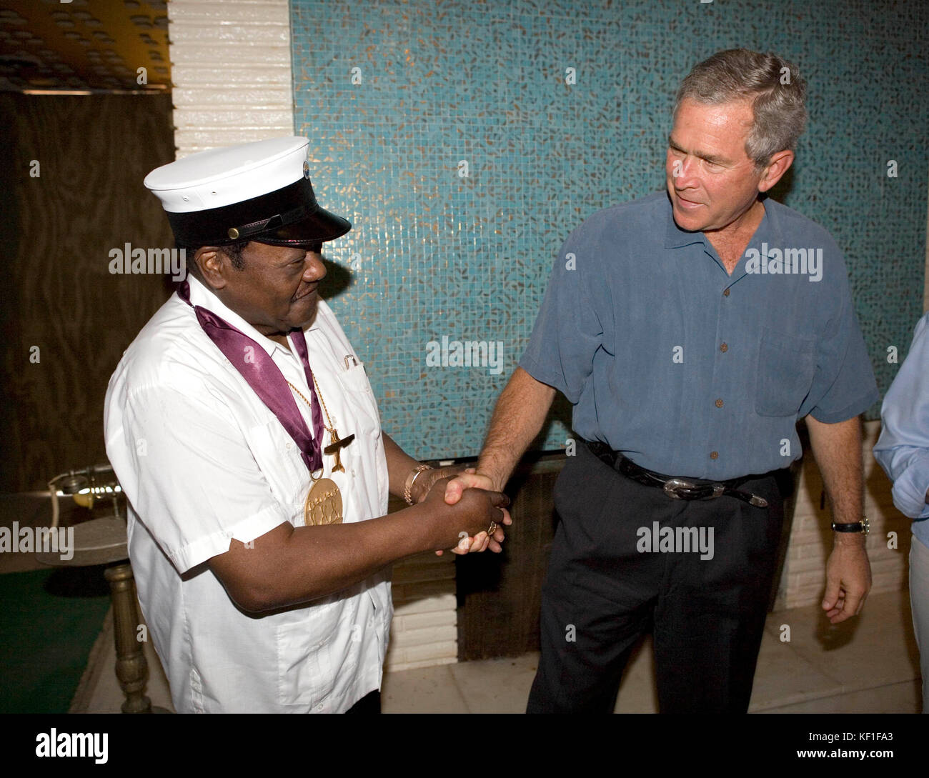 United States President George W. Bush shakes the hand of the legendary Fats Domino, wearing a National Medal of Arts, after the President presented it Tuesday, August 29, 2006, at the musician's home in the Lower 9th Ward of New Orleans. The medal was a replacement medal for the one -- originally awarded by President Bill Clinton -- that was lost in the flood waters of Hurricane Katrina. Mandatory Credit: Eric Draper/White House via CNP/MediaPunch Stock Photo