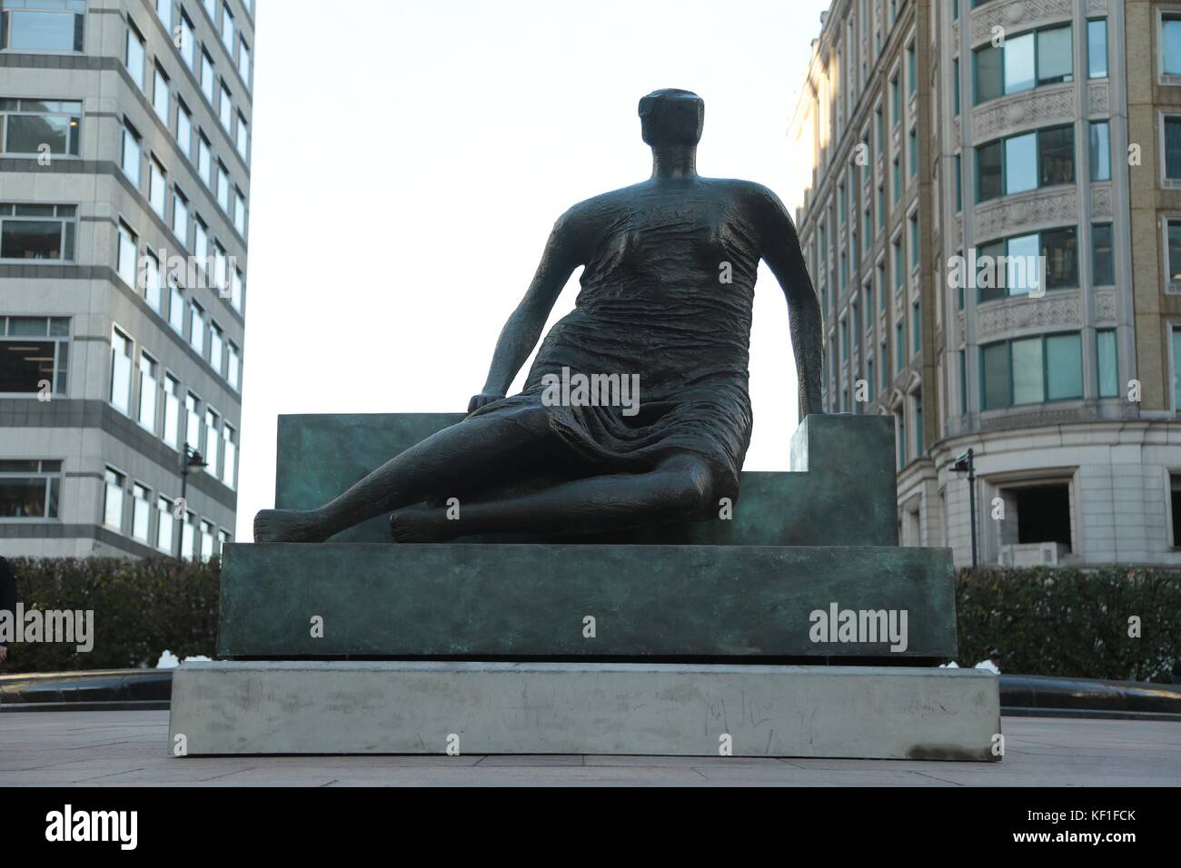 London, UK. 25th October, 2017. Henry Moore sculpture Draped Seated Woman returns to the East End after 20 years “Old Flo” is an East Ender again, as she relocates to her new home in Canary Wharf Henry Moore's Draped Seated Woman has made a triumphant return to the East End, following a twenty year stay in Yorkshire. Known affectionately as ‘Old Flo', the famous bronze sculpture was originally housed on the Stifford Estate in Stepney, having been purchased from the sculptor by the London County Council (LCC) in 1962 as part of its inspirational Patronage of the Arts scheme. Stock Photo