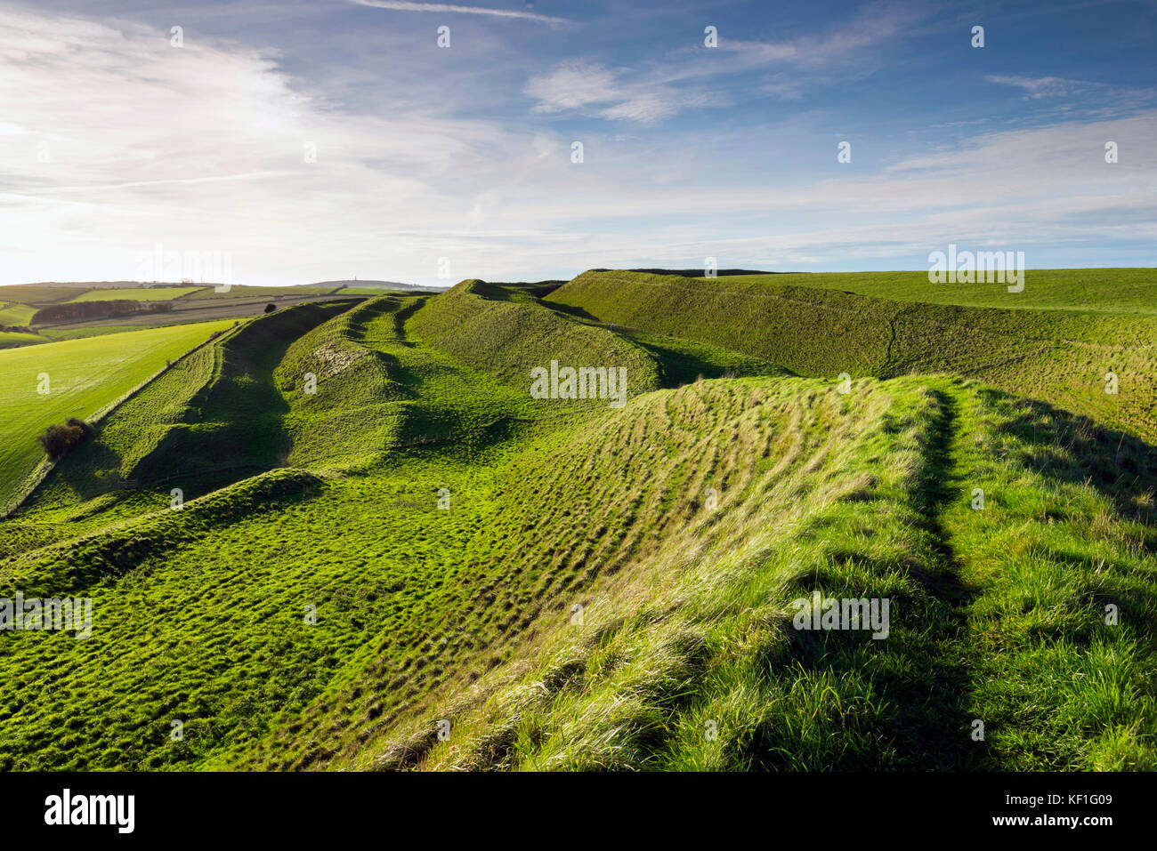 Maiden Castle, Dorchester, UK.  25th October 2017.  UK Weather.  Late afternoon autumn sunshine at Maiden Castle iron age hill fort near Dorchester in Dorset.  Photo Credit: Graham Hunt/Alamy Live News Stock Photo