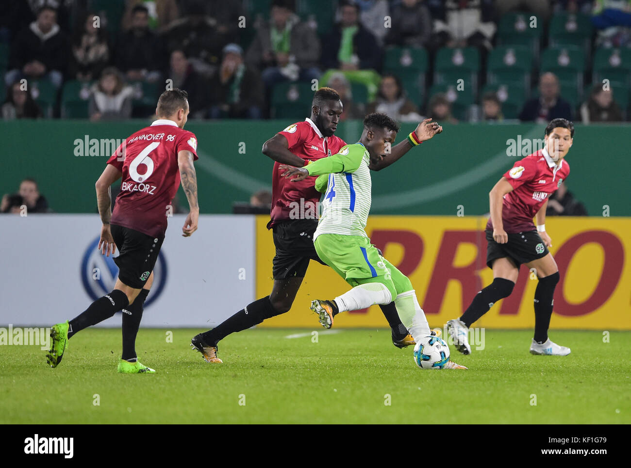 Wolfsburg's Divock Origi (2nd from right) and Hannover's Salif Sane (2nd from left) vying for the ball while to the left stand Hannover's Marvin Bakalorz and Miiko Albornoz (R) during the DFB Cup soccer match between VfL Wolfsburg and Hannover 96 in the Volkswagen Arena in Wolfsburg, Germany, 25 October 2017. (EMBARGO CONDITIONS - ATTENTION: The DFB prohibits the utilisation and publication of sequential pictures on the internet and other online media during the match (including half-time). ATTENTION: BLOCKING PERIOD! The DFB permits the further utilisation and publication of the pictures f Stock Photo