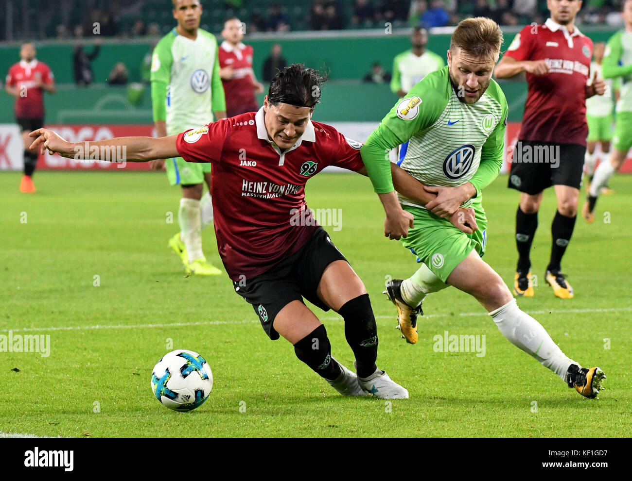 Wolfsburg's Jakub Blaszczykowski (R) and Hannover's Miiko Albornoz vying for the ball during the DFB Cup soccer match between VfL Wolfsburg and Hannover 96 in the Volkswagen Arena in Wolfsburg, Germany, 25 October 2017. (EMBARGO CONDITIONS - ATTENTION: The DFB prohibits the utilisation and publication of sequential pictures on the internet and other online media during the match (including half-time). ATTENTION: BLOCKING PERIOD! The DFB permits the further utilisation and publication of the pictures for mobile services (especially MMS) and for DVB-H and DMB only after the end of the match.) Stock Photo