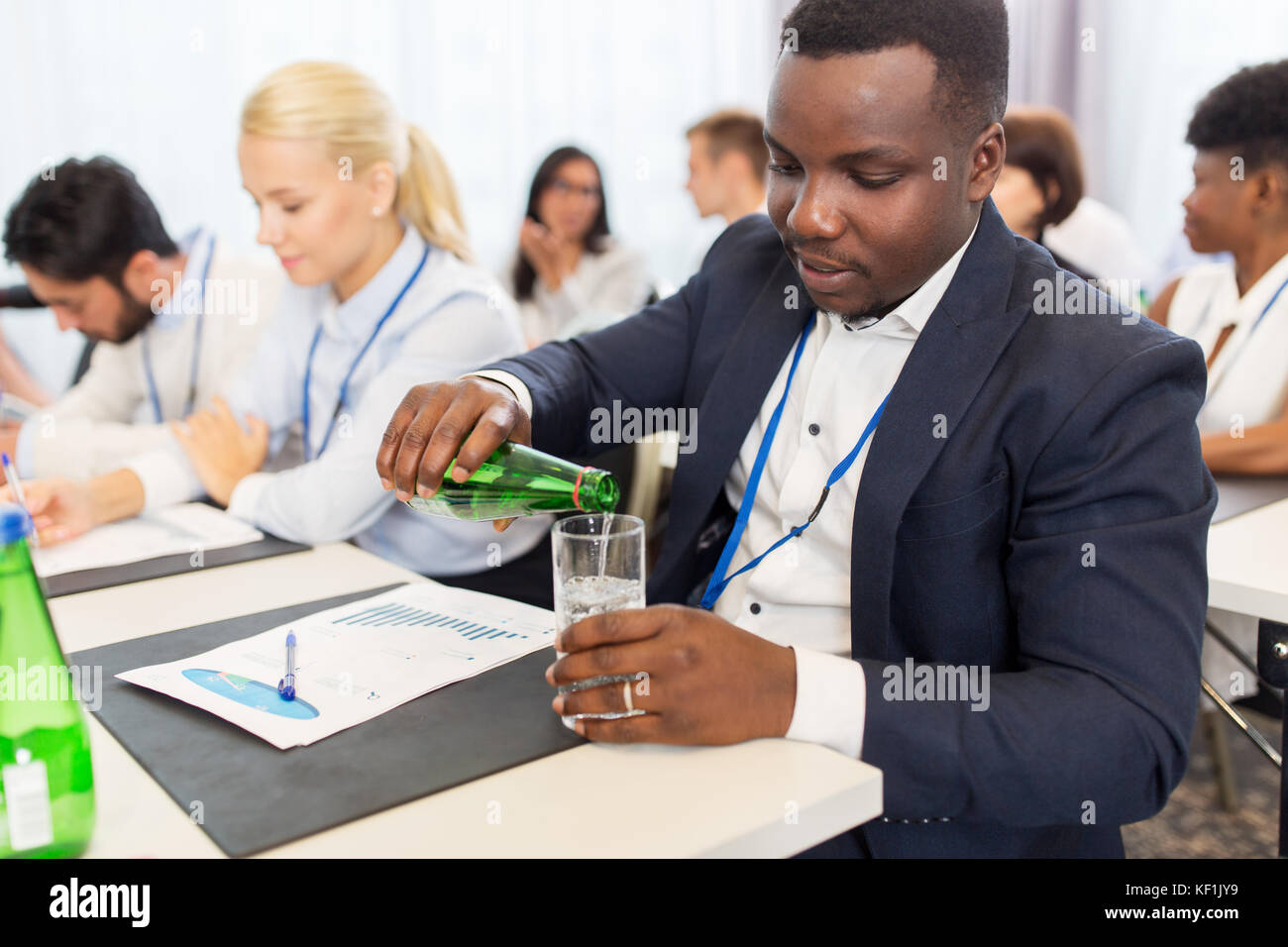 businessman drinking water at business conference Stock Photo