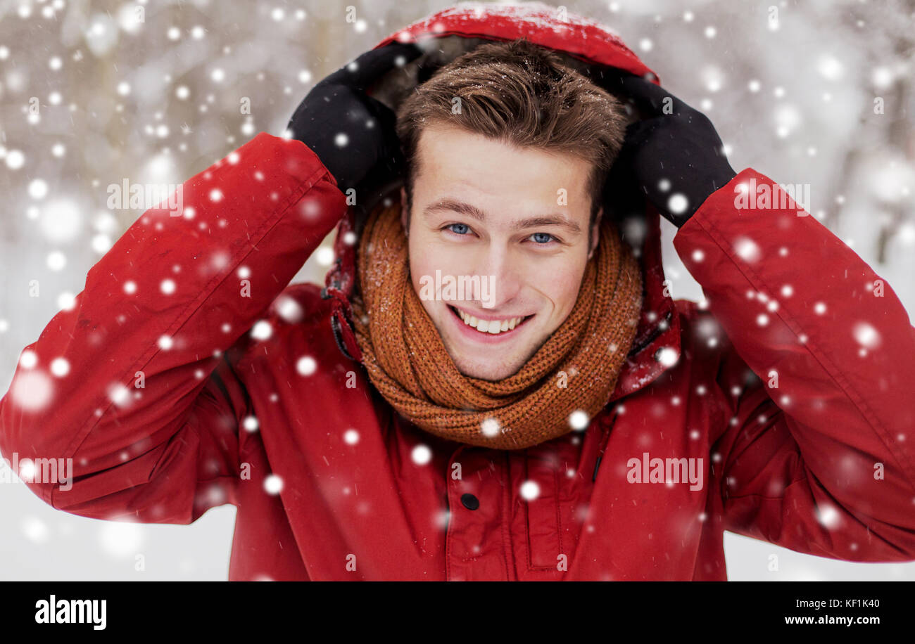 happy man in winter jacket with hood outdoors Stock Photo - Alamy