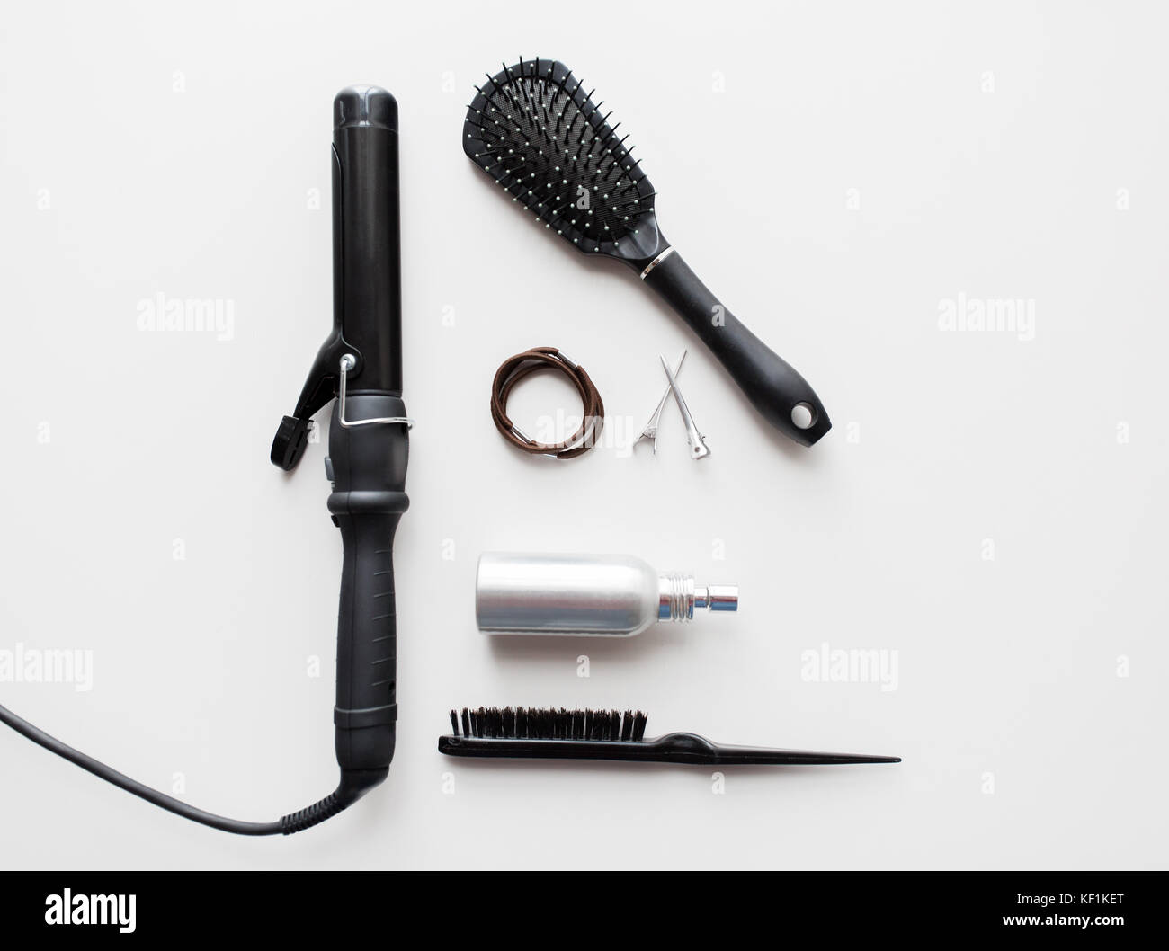 iron, brushes, styling spay, hair ties and pins Stock Photo