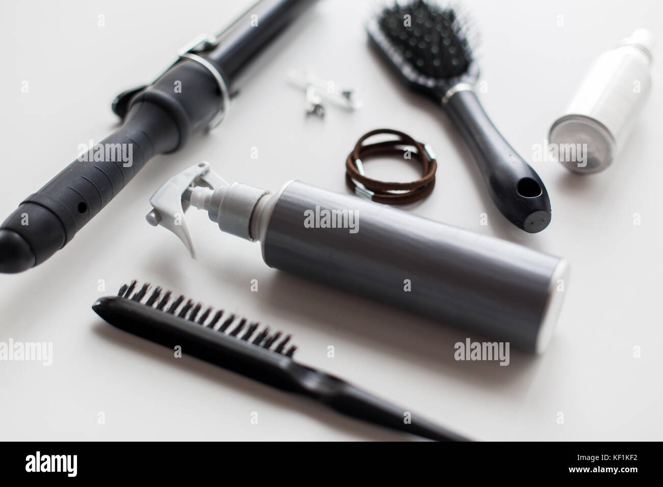 styling spay, brushes, hair ties and curling iron Stock Photo
