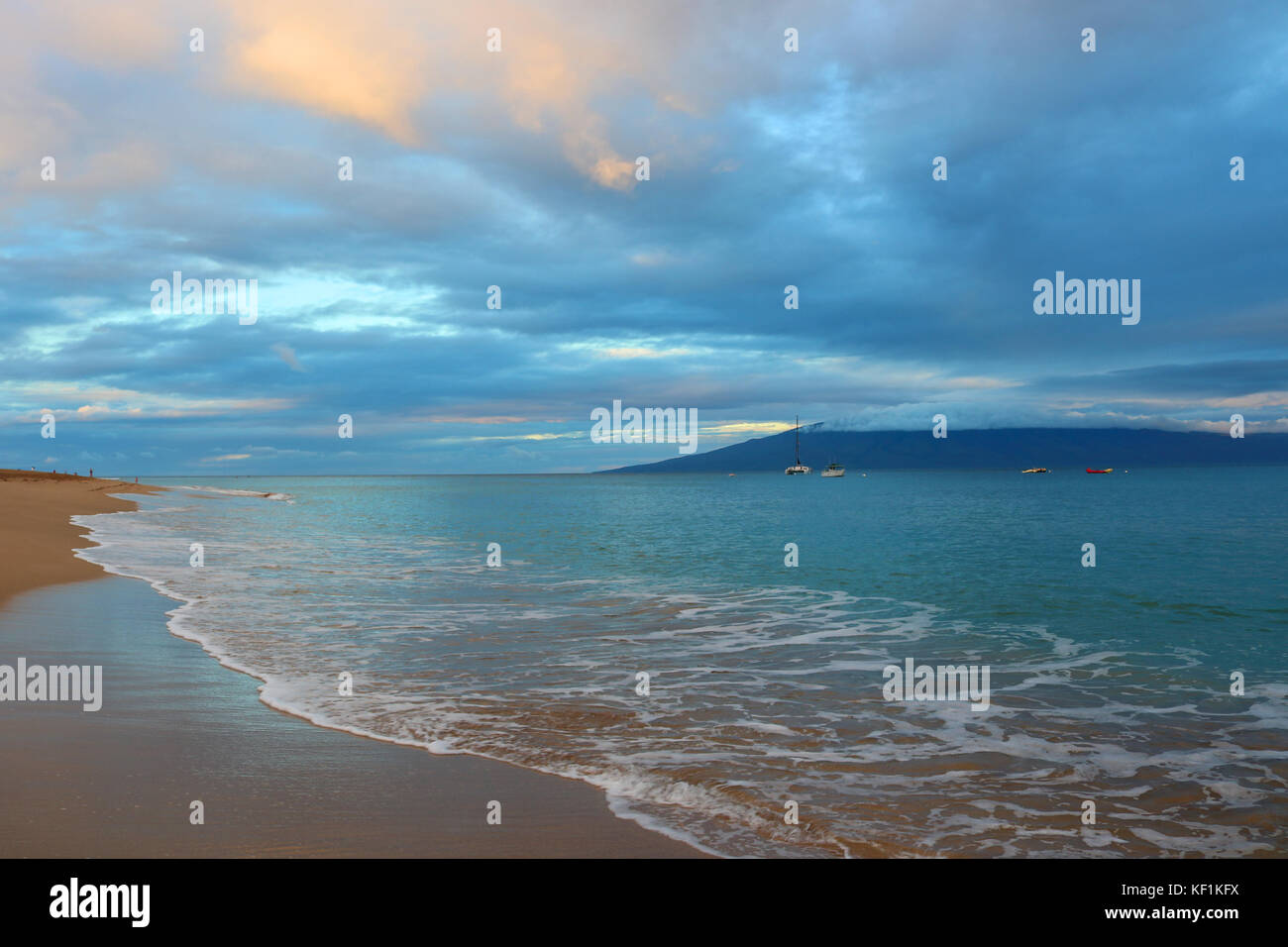 Morning on Peaceful Beach with Turquoise Water and Blue Gray Clouds Stock Photo