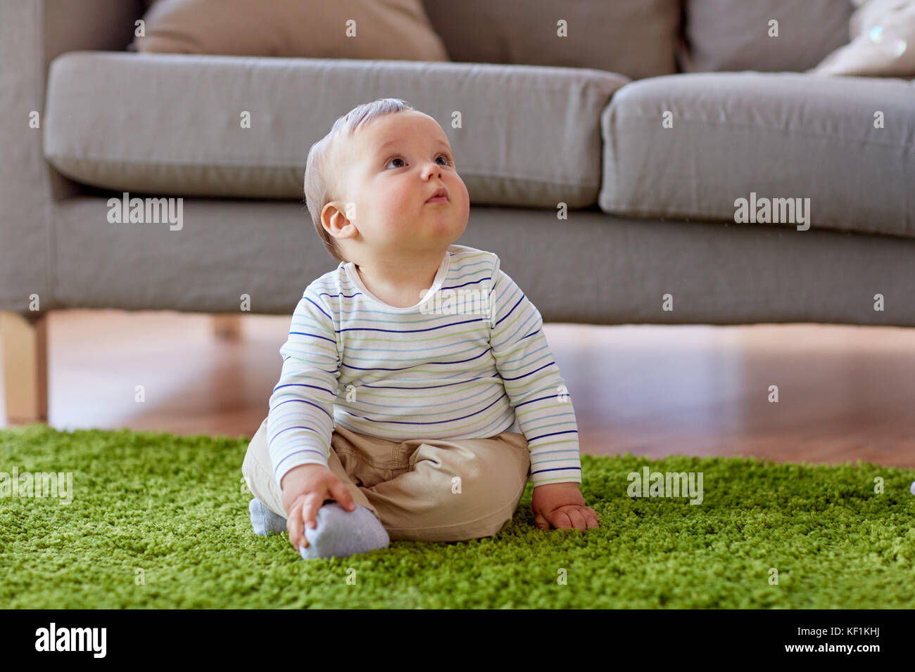 baby boy sitting on floor at home Stock Photo - Alamy
