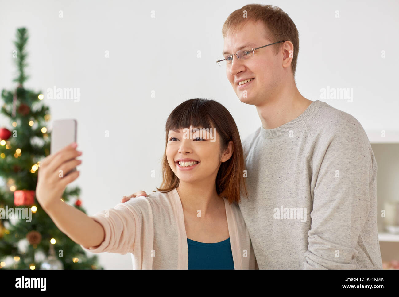 mixed-raced couple taking selfie at christmas Stock Photo