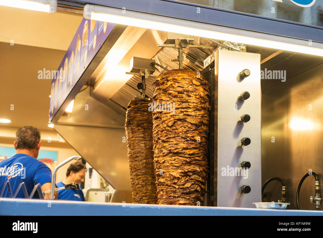 Brussels, Belgium - August 26, 2017: Kitchen of a Doner kebap with rolls of mutton or chicken and waiters in Brussels, Belgium Stock Photo
