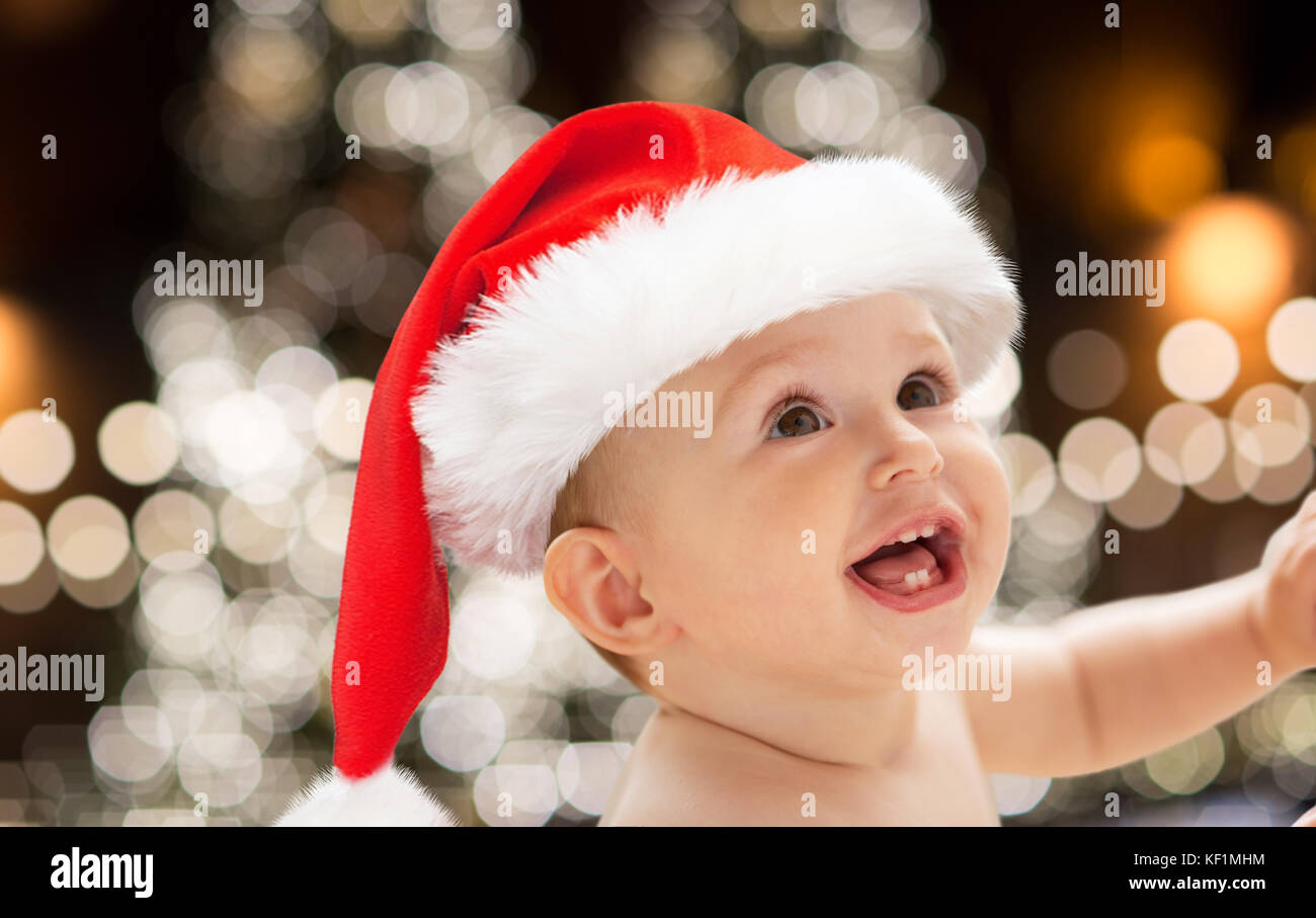 close up of little baby in santa hat at christmas Stock Photo
