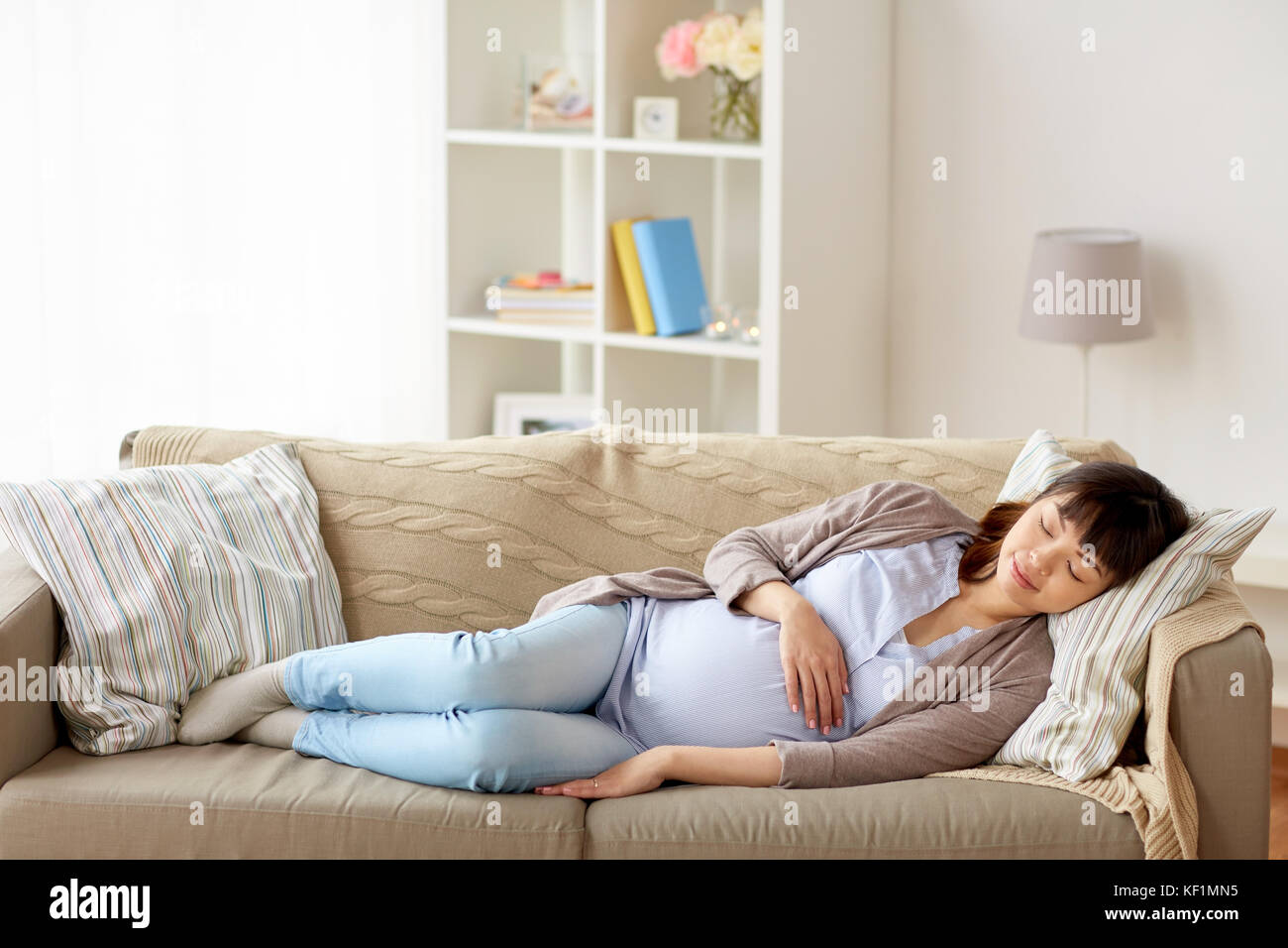 happy pregnant woman sleeping on sofa at home Stock Photo Alamy