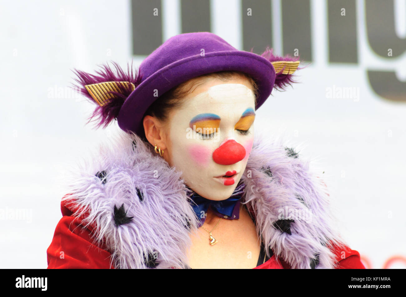 Female mime artist with painted face and costume performs on the high ...