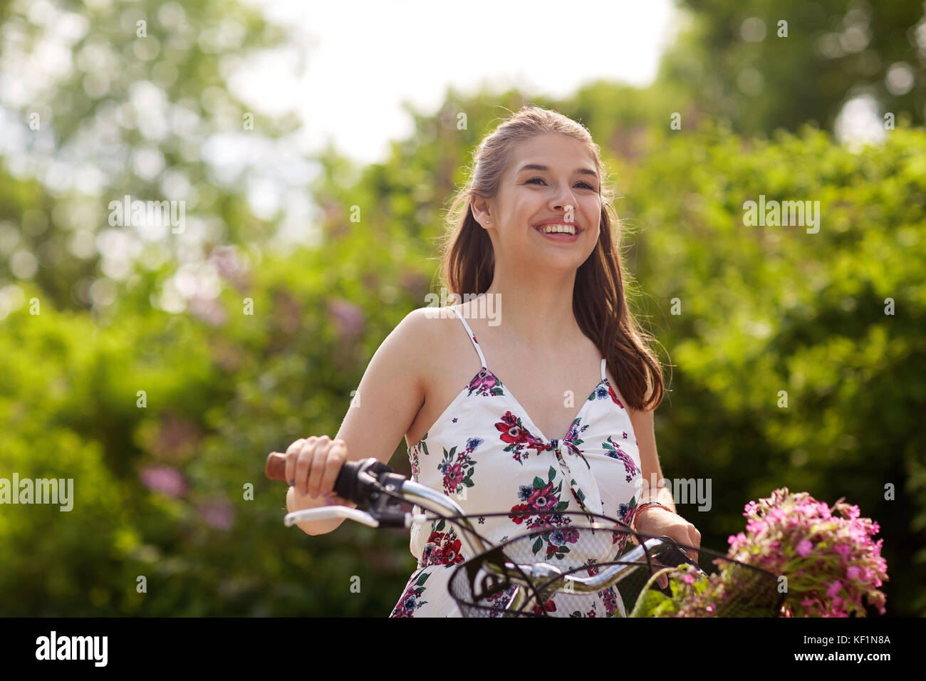 happy woman riding fixie bicycle in summer park Stock Photo